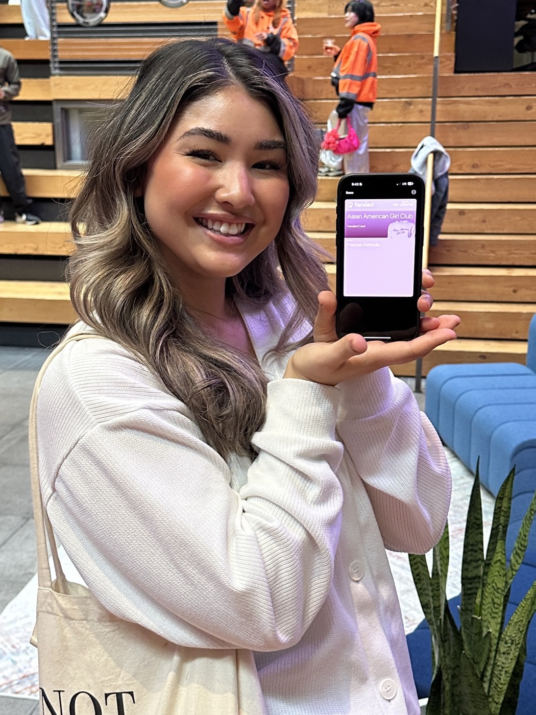 A club member showing her membership card in her phone wallet